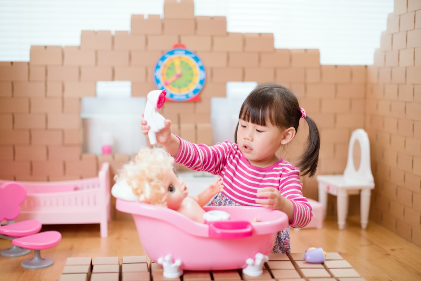 A young child caring for a doll during play