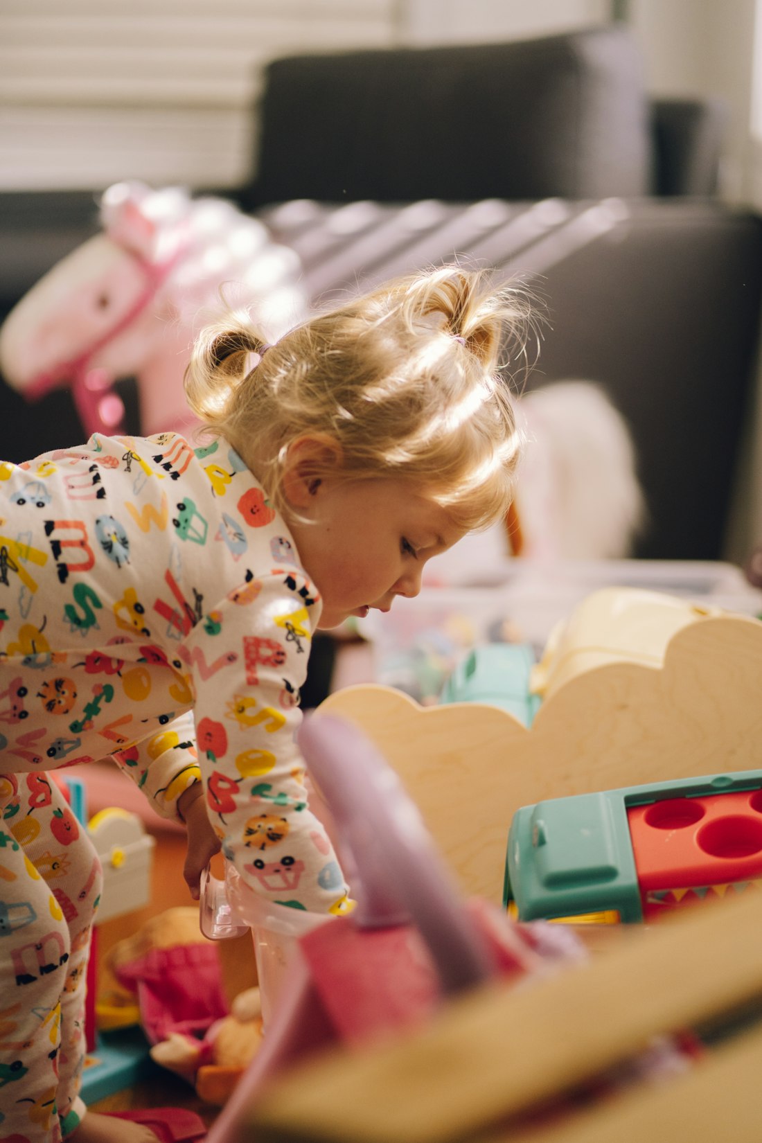 A young child absorbed in play with toys